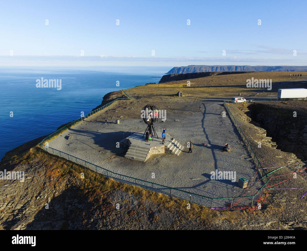Aerial view of people at the sphere, on a sunny autumn day, in Nordkapp, Norway Stock Photo