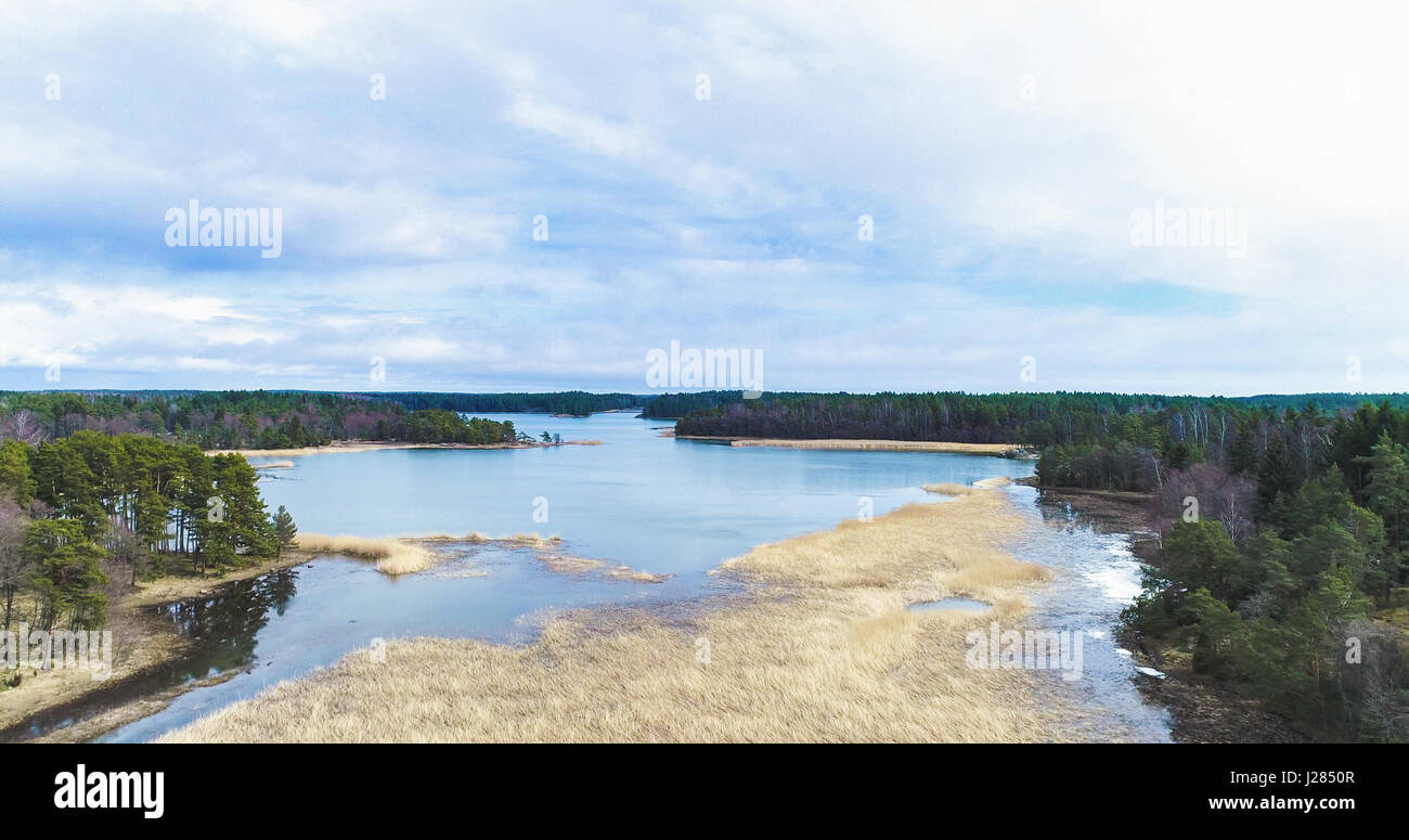 Aerial view of a cloudy spring day, above bed of reeds, the baltic sea and between the islands in the archipelago Stock Photo