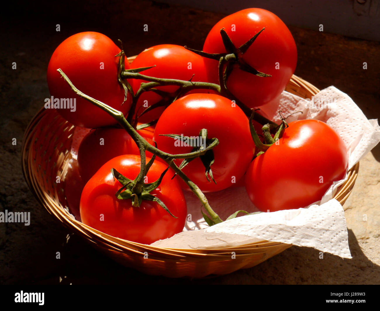 Ripe grape tomatoes in a wicker basket Stock Photo - Alamy