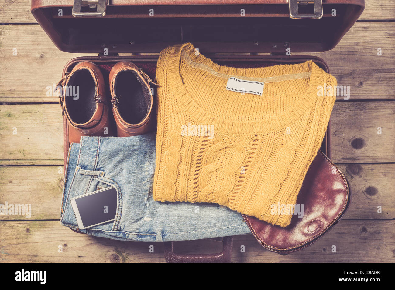 Open suitcase with casual female clothes Stock Photo
