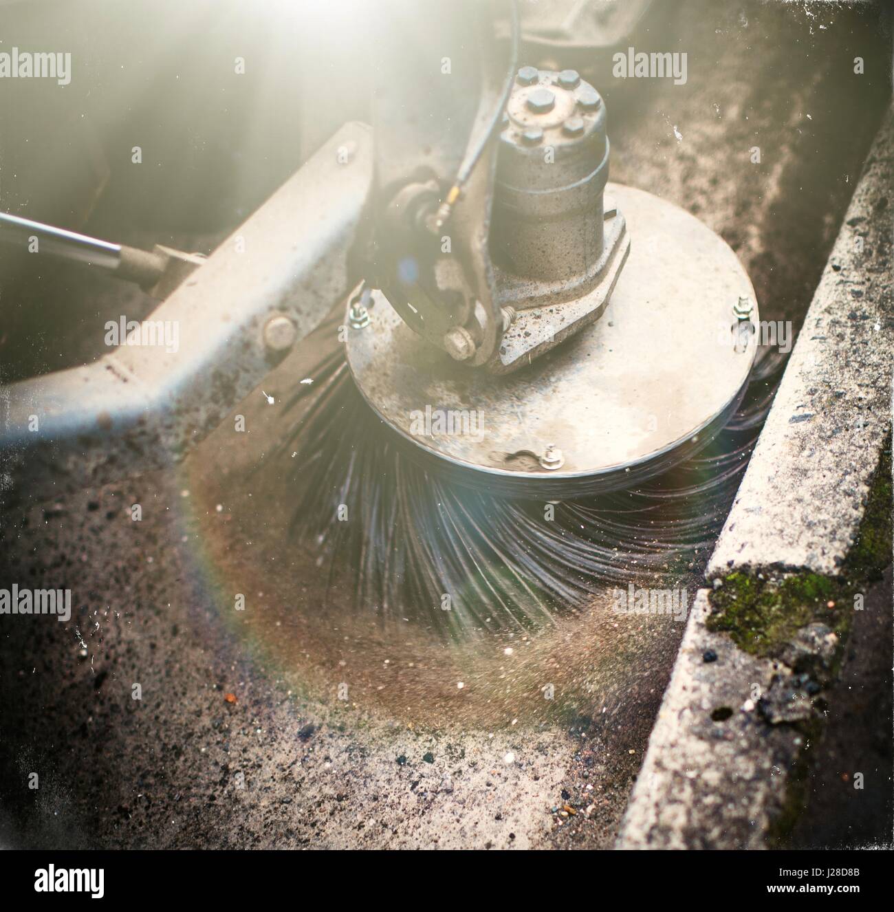 Resurfacing road actions with swirling and oscillating brush Stock Photo