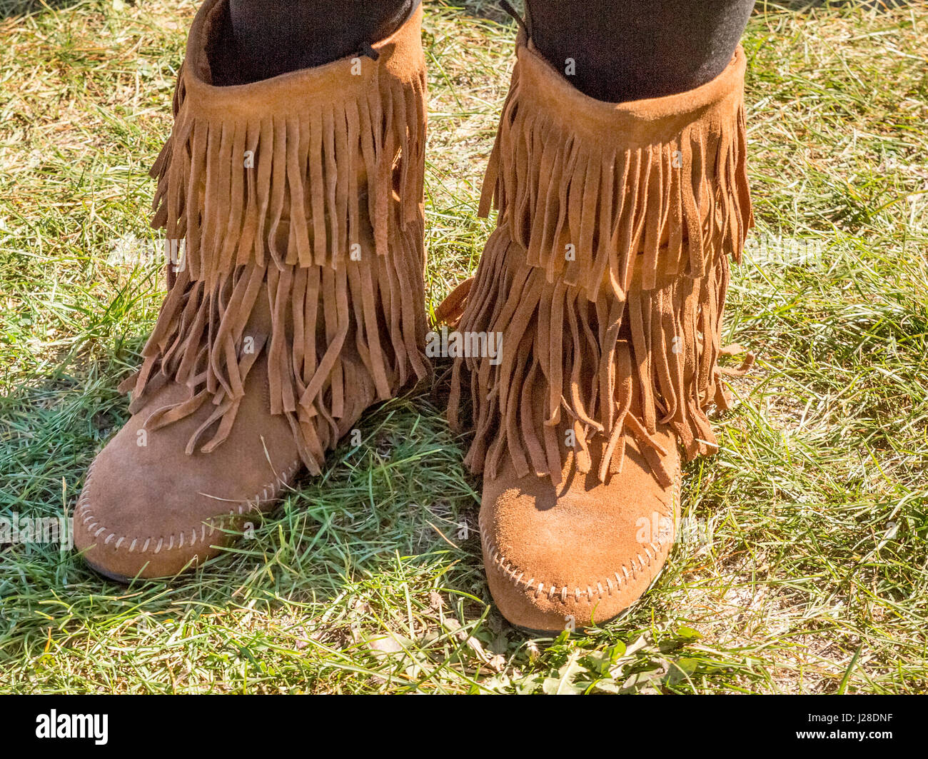 Adult wearing a pair of handmade native moccasins at a Native North