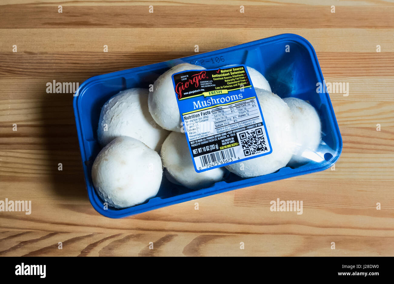 A package of button mushrooms Stock Photo