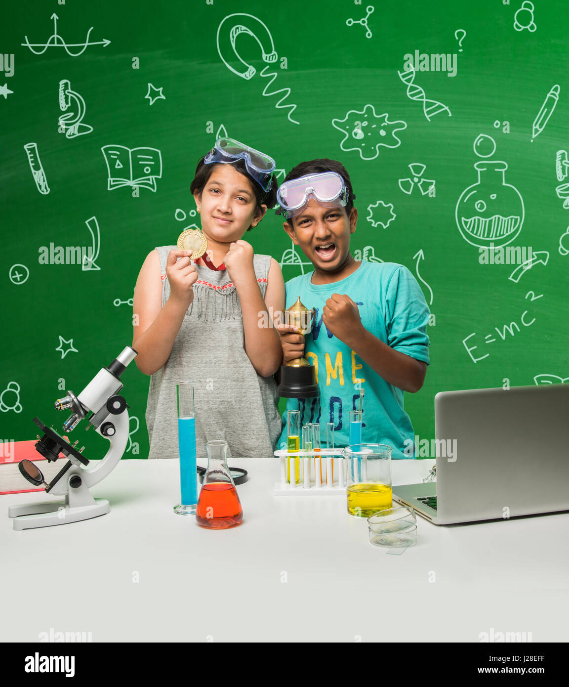 cute indian kids doing science experiment in chemistry lab or biology lab in school Stock Photo