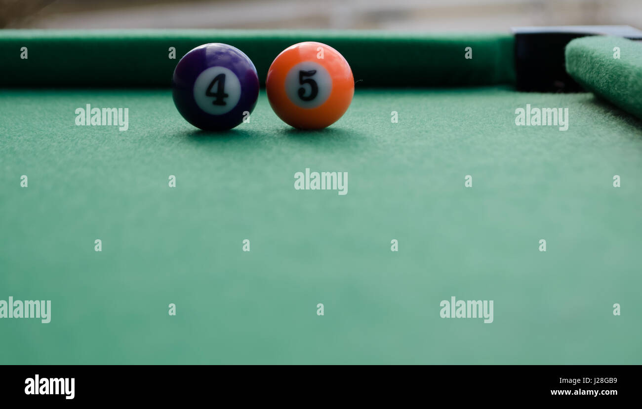 Billiard balls forming number 45 on filt table in front of corner pocket 45th president concept Stock Photo