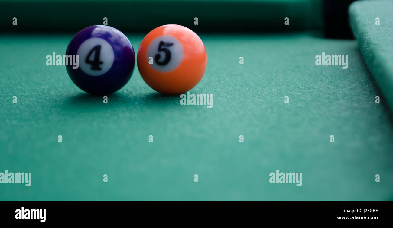Billiard balls forming number 45 on filt table in front of corner pocket 45th president concept Stock Photo