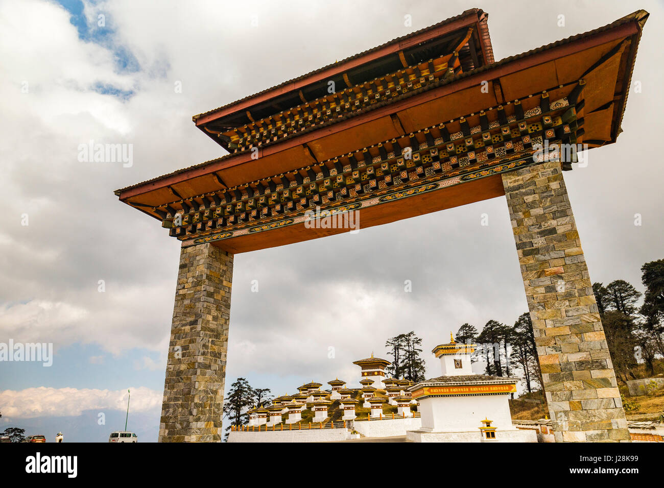 The stupas in the Druk Wangyal Chortens in the Dochula pass of Bhutan under a cloudy sky Stock Photo