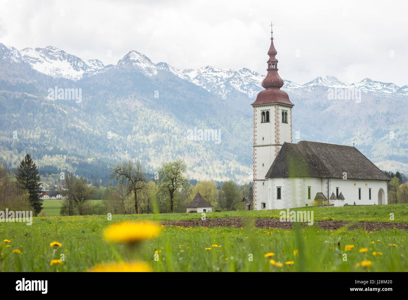catholic church in field among Alps Stock Photo - Alamy