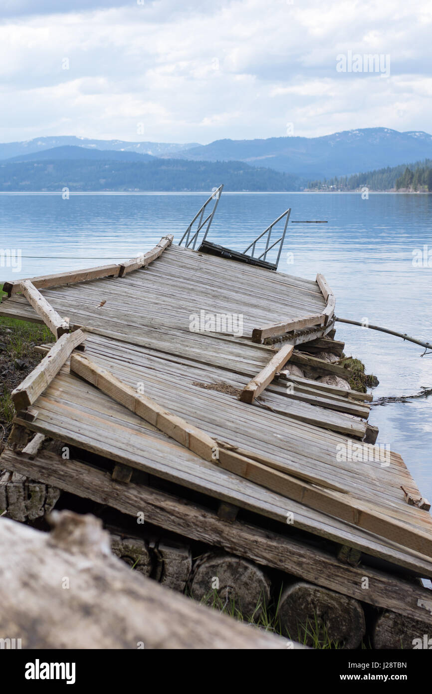 Damaged boat dock on edge of Lake Coeur d'Alene after harsh winter and flooding rains. Stock Photo
