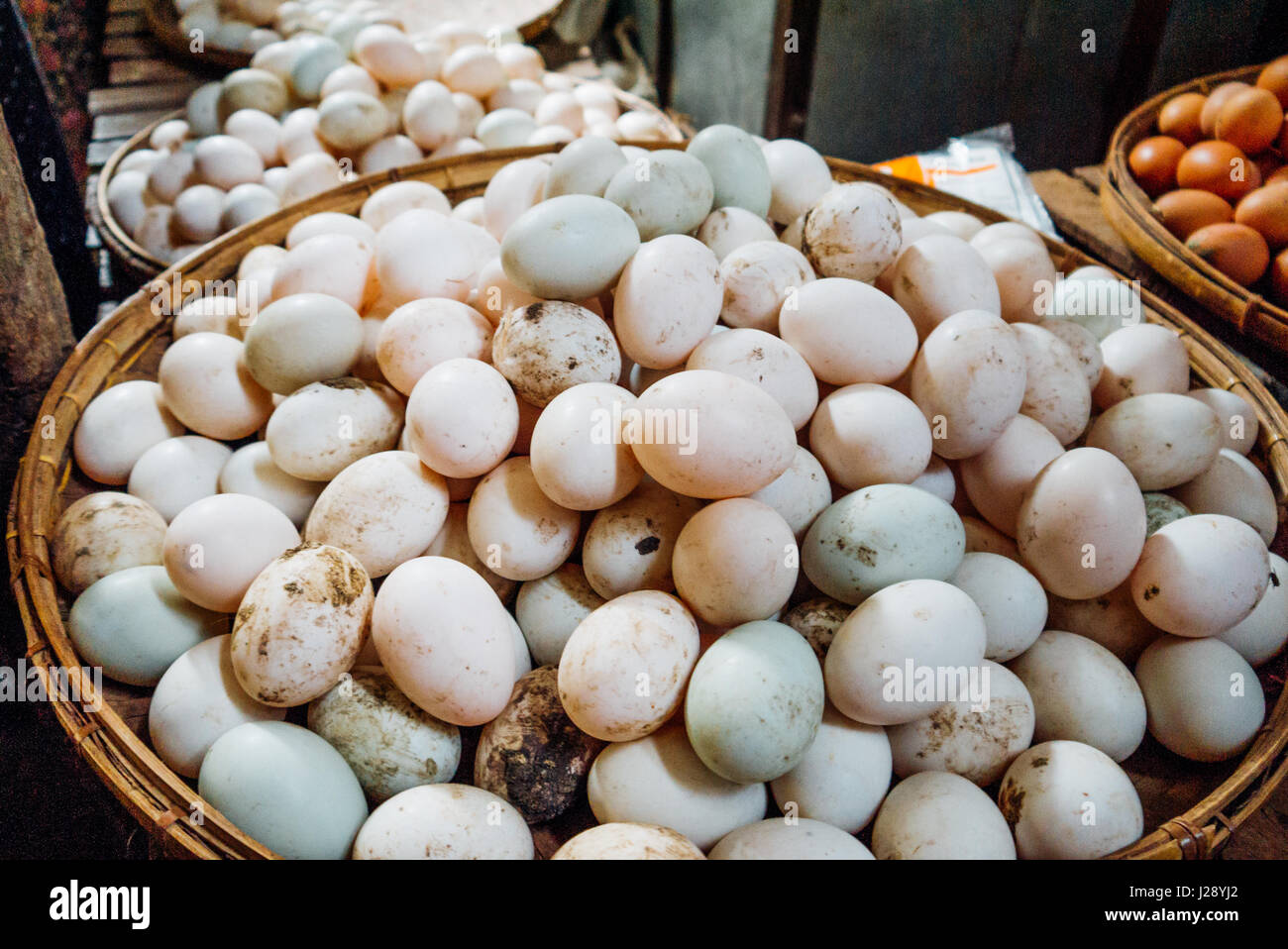 Stack of white eggs on a rattan tray at a market in Bagan, Myanmar. Stock Photo