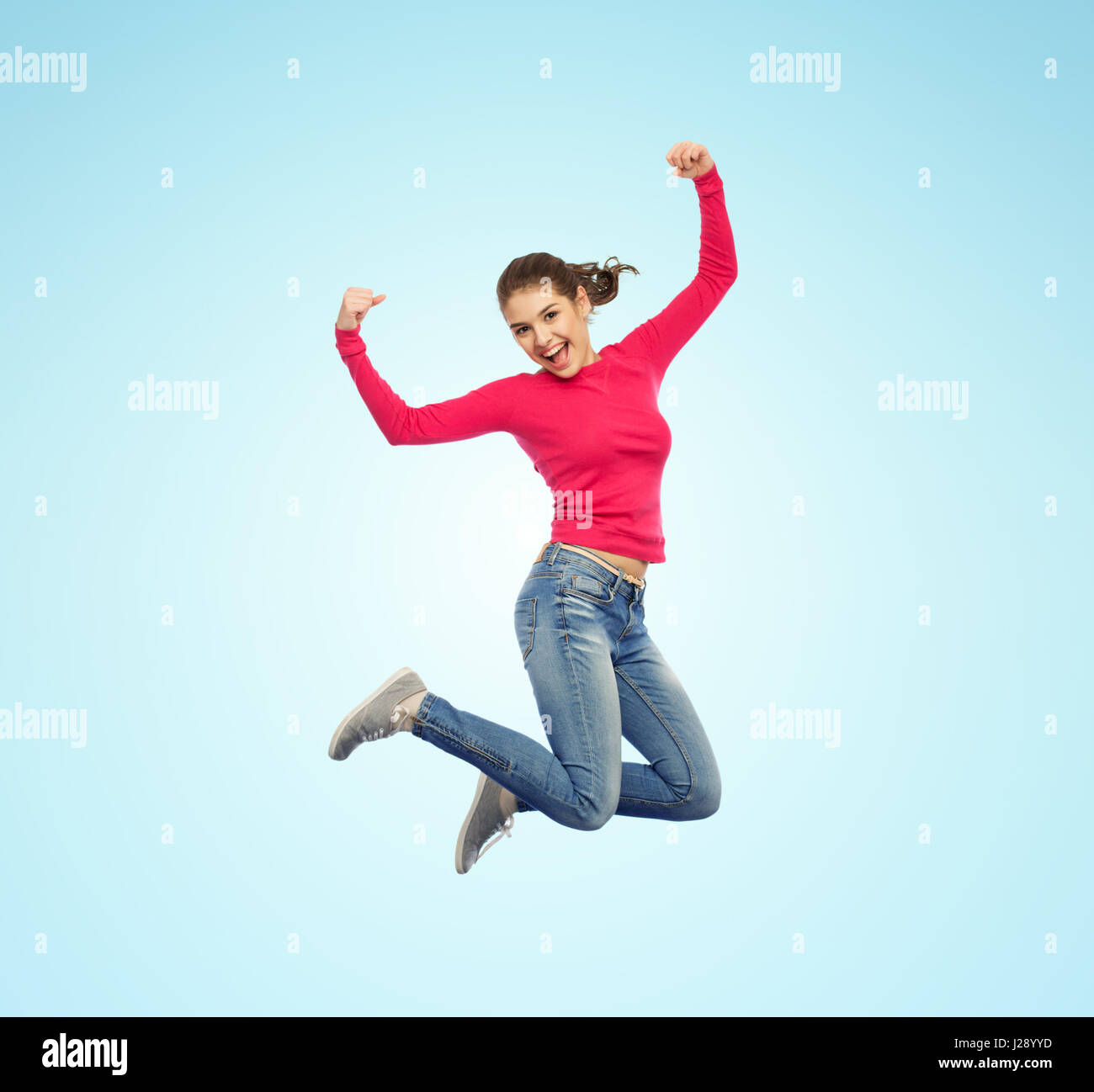 smiling young woman jumping in air Stock Photo - Alamy