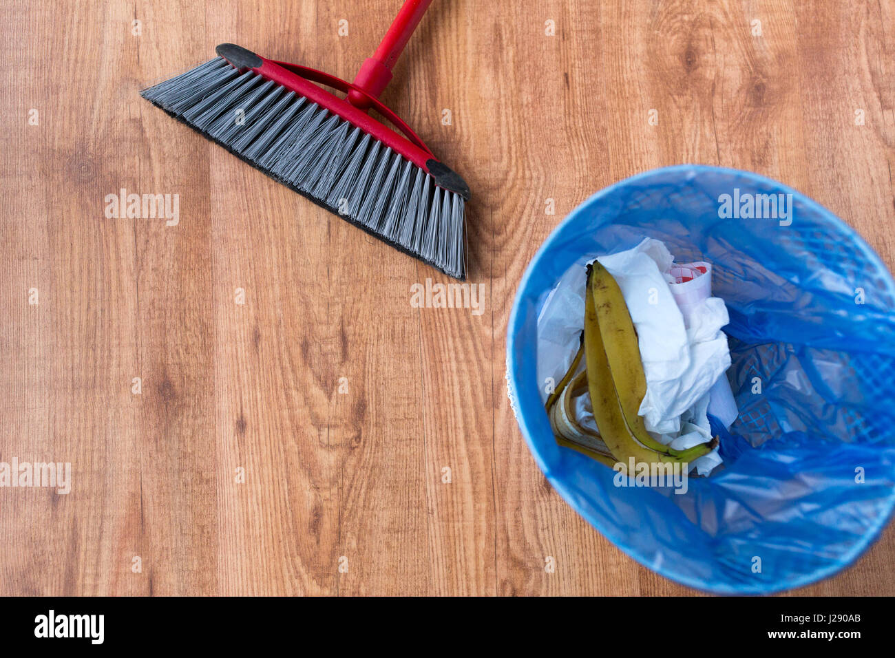 rubbish bag with trash and cleaning items at home Stock Photo