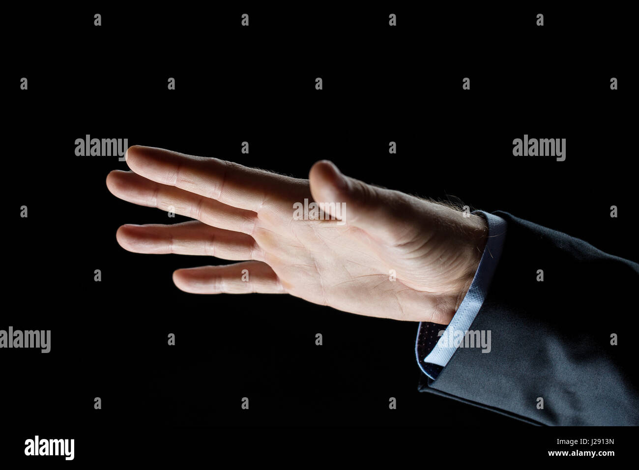 Hand Over Backdrop close up of businessman hand over black background Stock Photo - Alamy