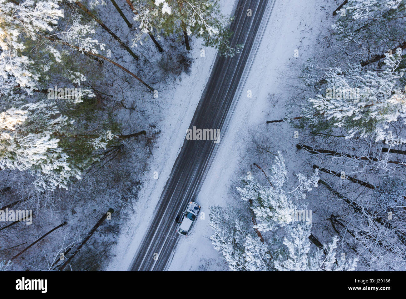 Road in a winter forest from above Stock Photo - Alamy