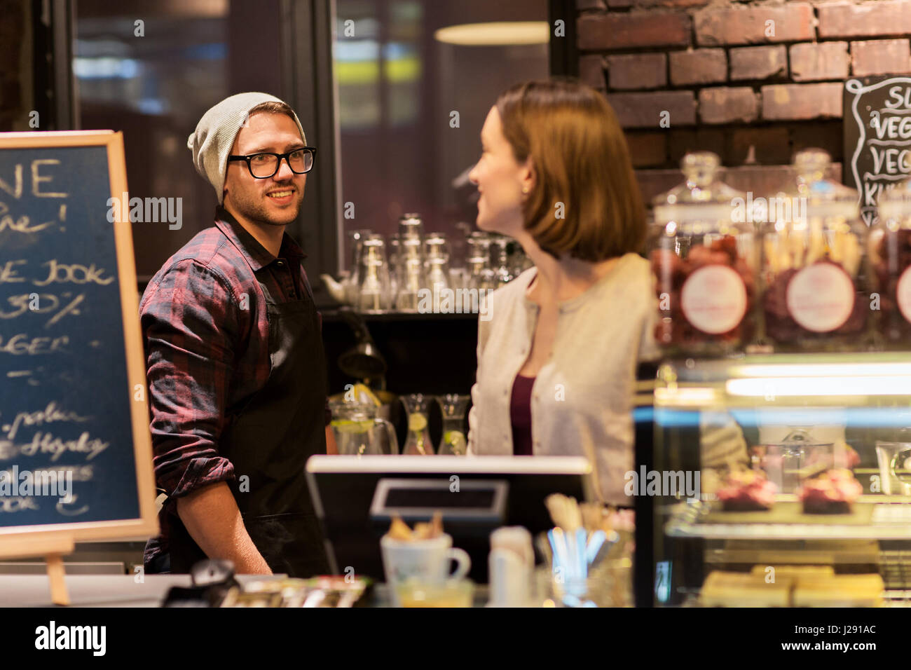 happy bartenders at cafe or coffee shop counter Stock Photo