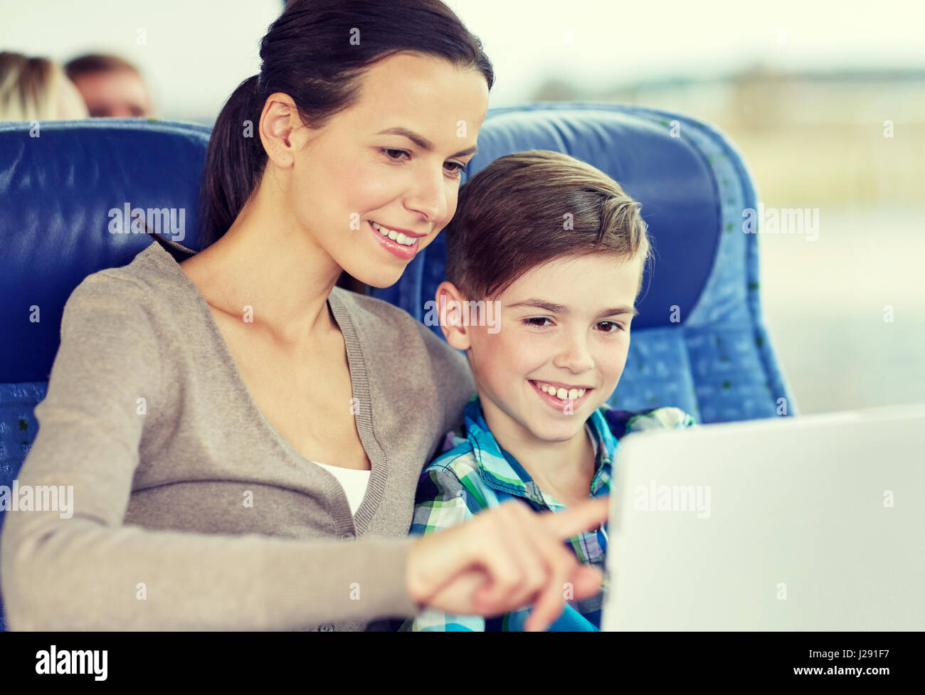happy family with tablet pc sitting in travel bus Stock Photo - Alamy