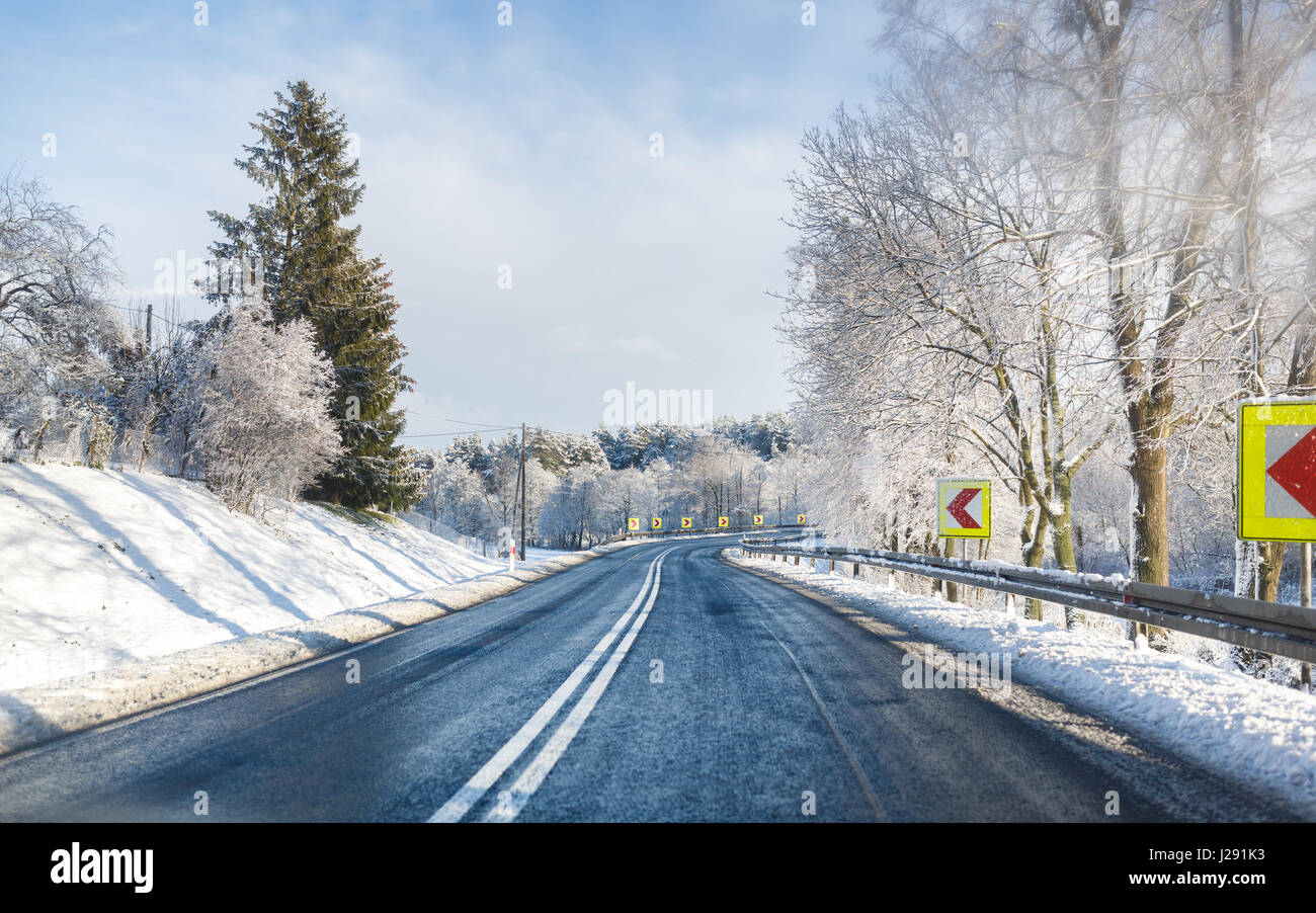 The road in a forest at winter time Stock Photo - Alamy