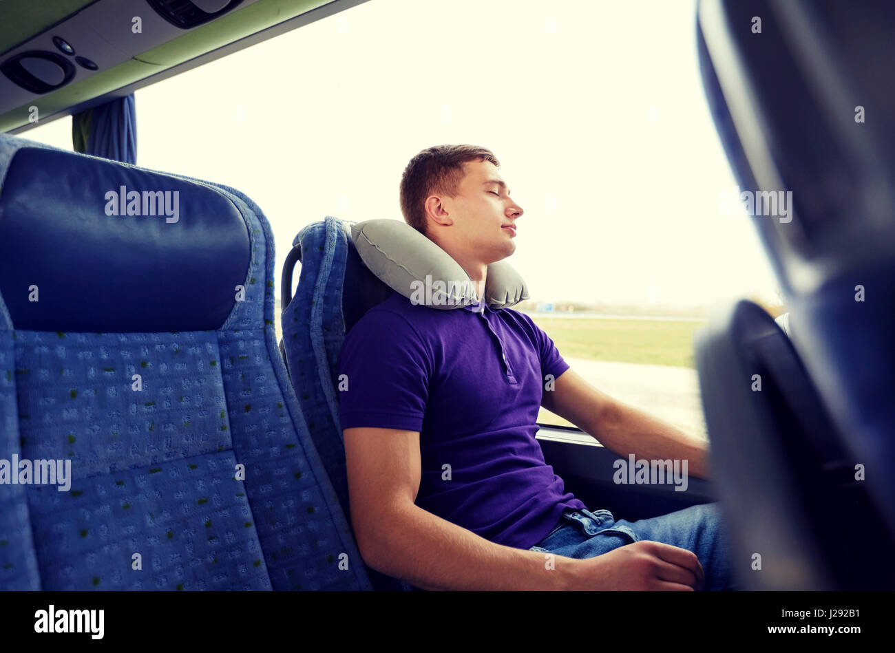 happy young man sleeping in travel bus with pillow Stock Photo Alamy
