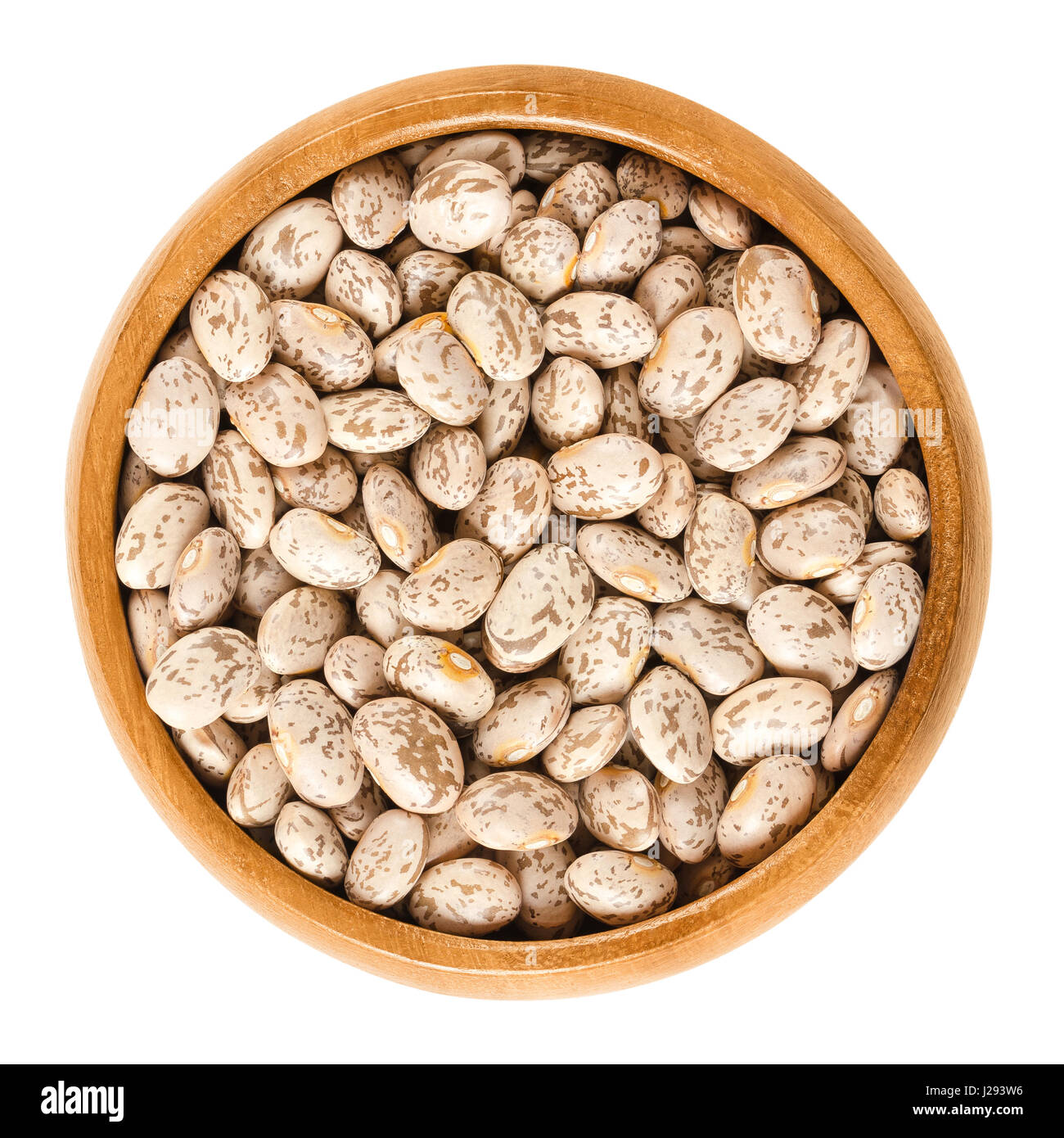 Pinto beans in wooden bowl. Dried variety of the common bean Phaseolus vulgaris. Speckled beans. Most popular bean in USA and Mexico. Stock Photo