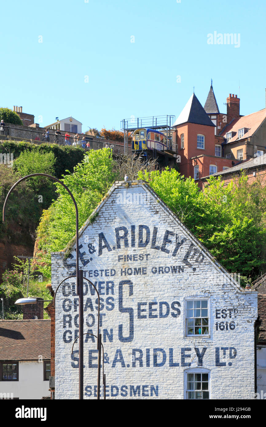 Old advertisement for S E & A Ridley seedsmen painted on the gable end of a building on Bridge Street and Cliff Railway above, Bridgnorth, Shropshire, Stock Photo