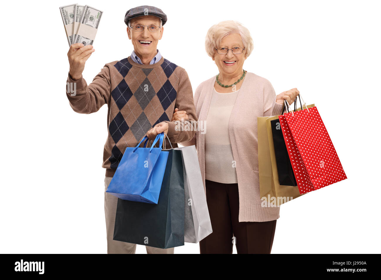 Cheerful seniors with bundles of money and shopping bags isolated on white background Stock Photo