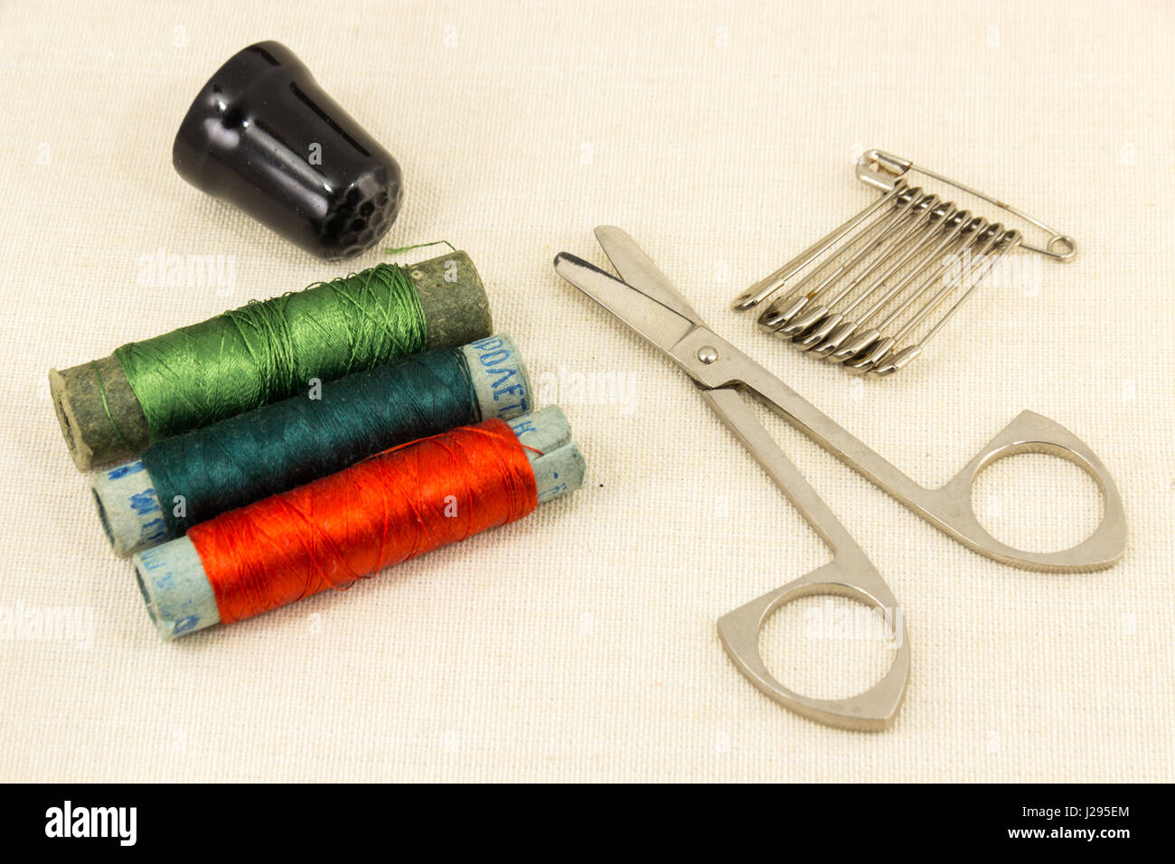 Beautifully laid out accessories for needlework on a fabric background Stock Photo