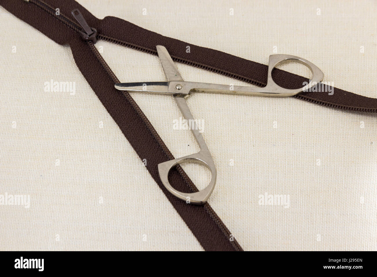Composition shears cut the zipper Stock Photo