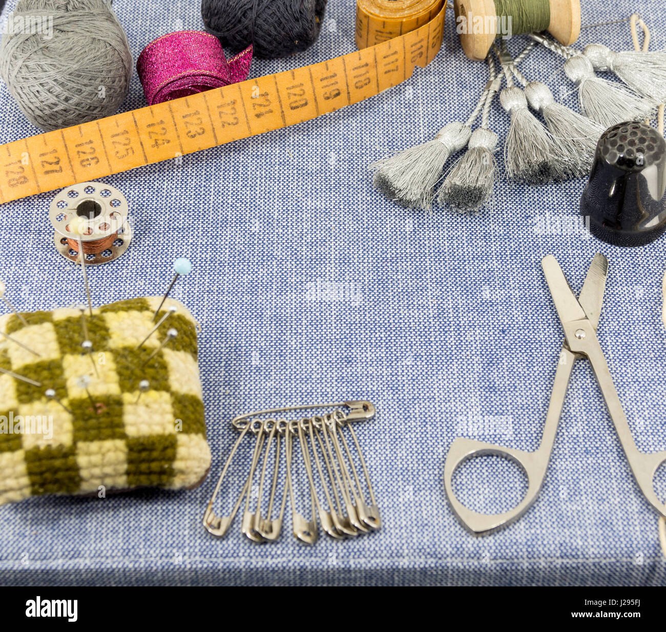 Beautifully laid out accessories for needlework on a jeans background Stock Photo