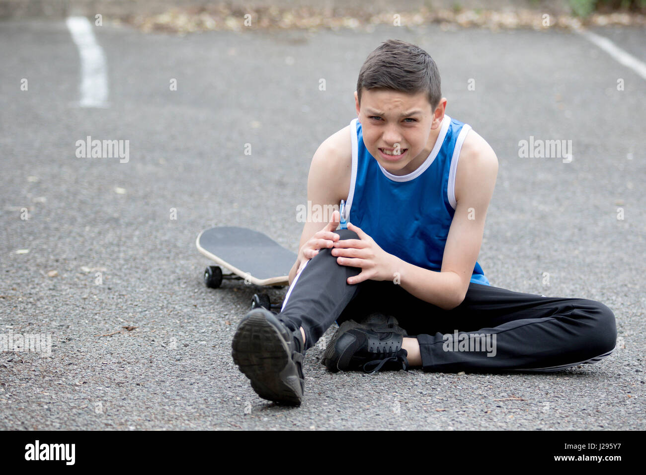 Teenage boy outside with a skateboard Stock Photo