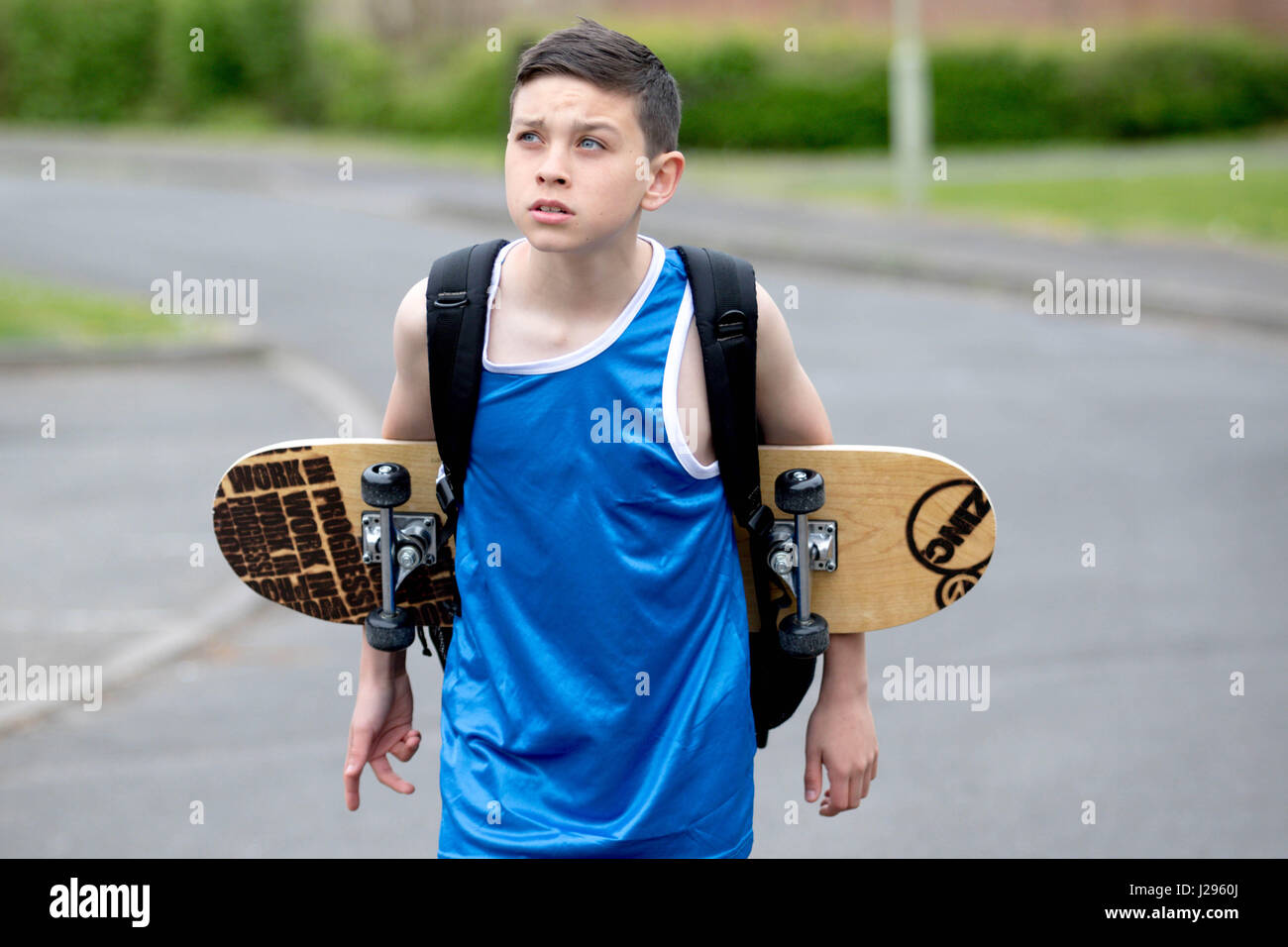 Teenage boy outside with a skateboard Stock Photo