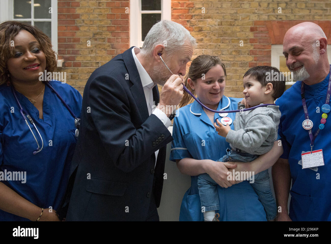 Labour leader Jeremy Corbyn pretends to use a stethoscope with 2-year-old Haroon, after he met NHS nurses, student nurses and midwives to discuss Labour&acirc;€™s three point election guarantee for NHS staff at the Florence Nightingale Museum, St Thomas&acirc;€™ Hospital in London. Stock Photo