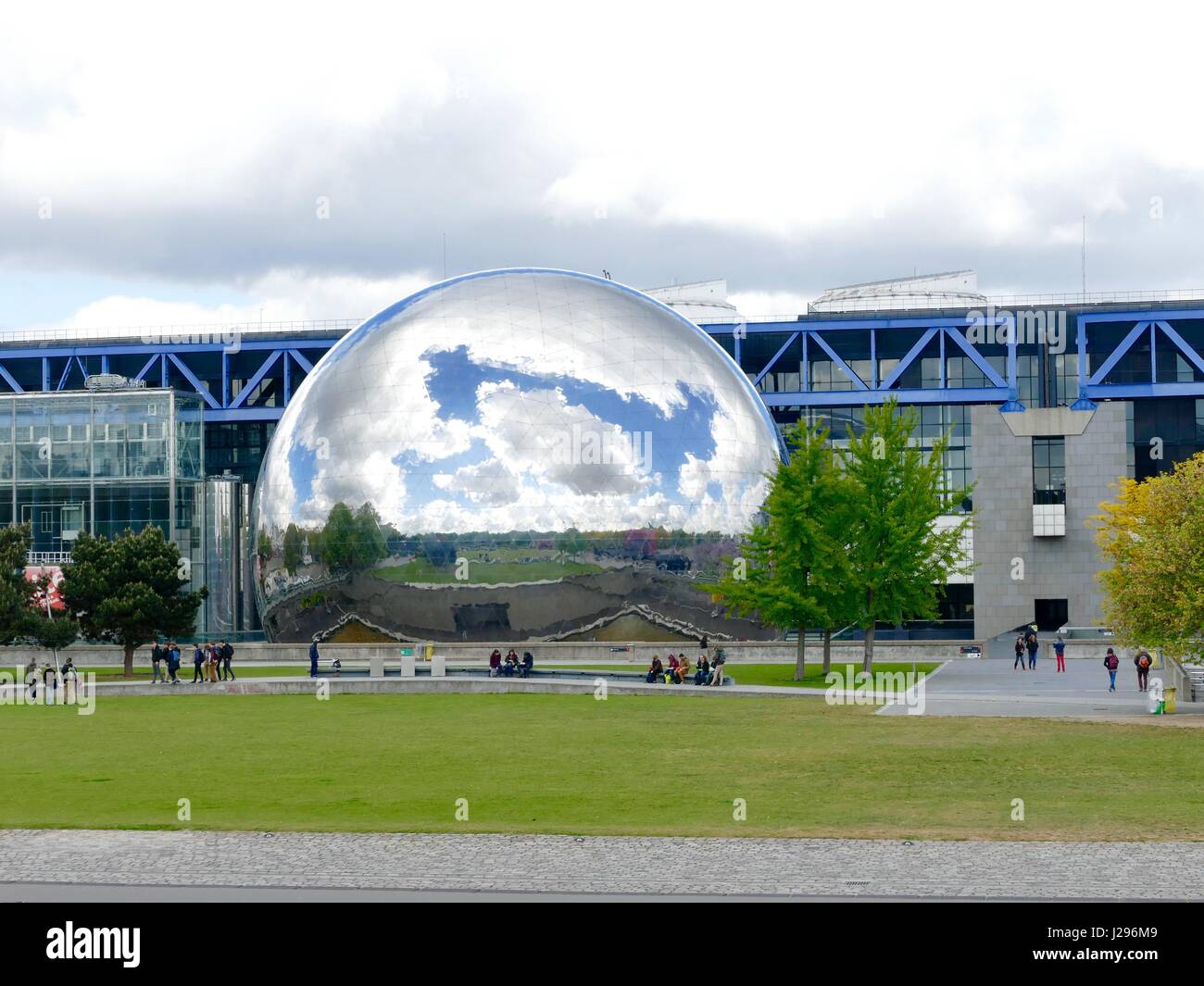 The géode at the Cité des Sciences et de l'Industrie at Parc de la Villette, 19th Arr., reflects vibrant blue sky and heavy clouds. Paris, France. Stock Photo