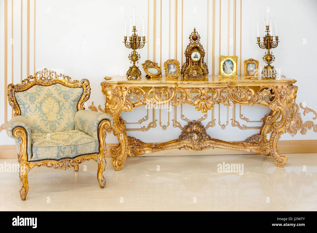Luxury livingroom in light colors with golden furniture details