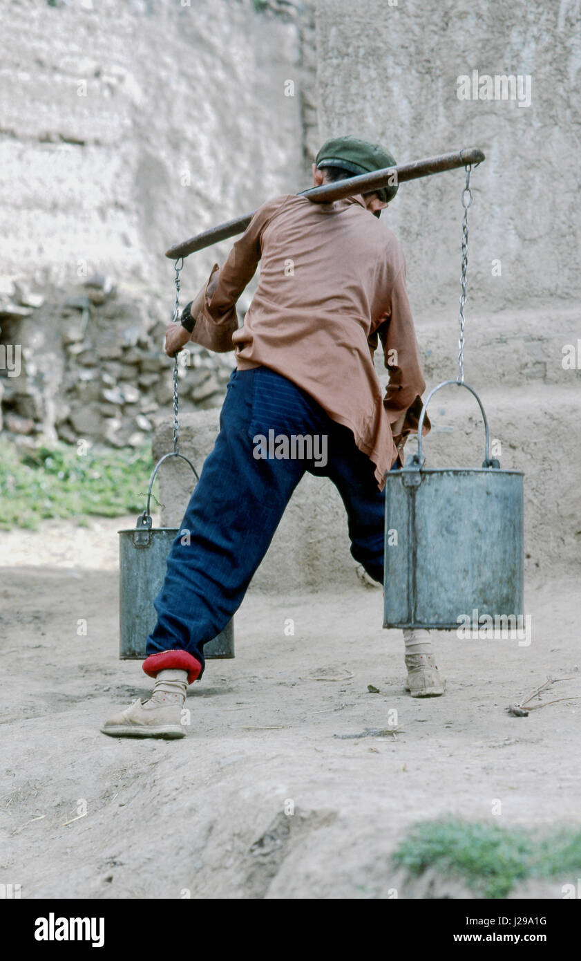 Carrying water with buckets hires stock photography and images Alamy