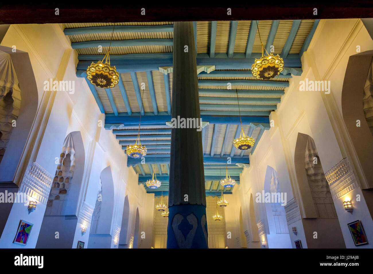 Interior with pillar and blue wooden ceiling of Registan madrasah, Samarkand, Uzbekistan Stock Photo