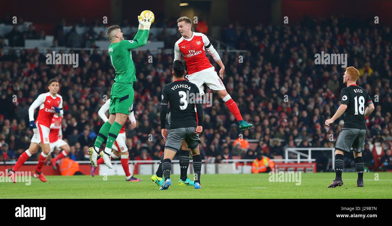 Southampton's keeper Fraser Forster safely collects the ball  from Arsenals Rob Holding during the EFL Cup Quater-final match between Arsenal and Southampton at the Emirates Stadium in London. November 30, 2016. EDITORIAL USE ONLY - FA Premier League and Football League images are subject to DataCo Licence see www.football-dataco.com Stock Photo
