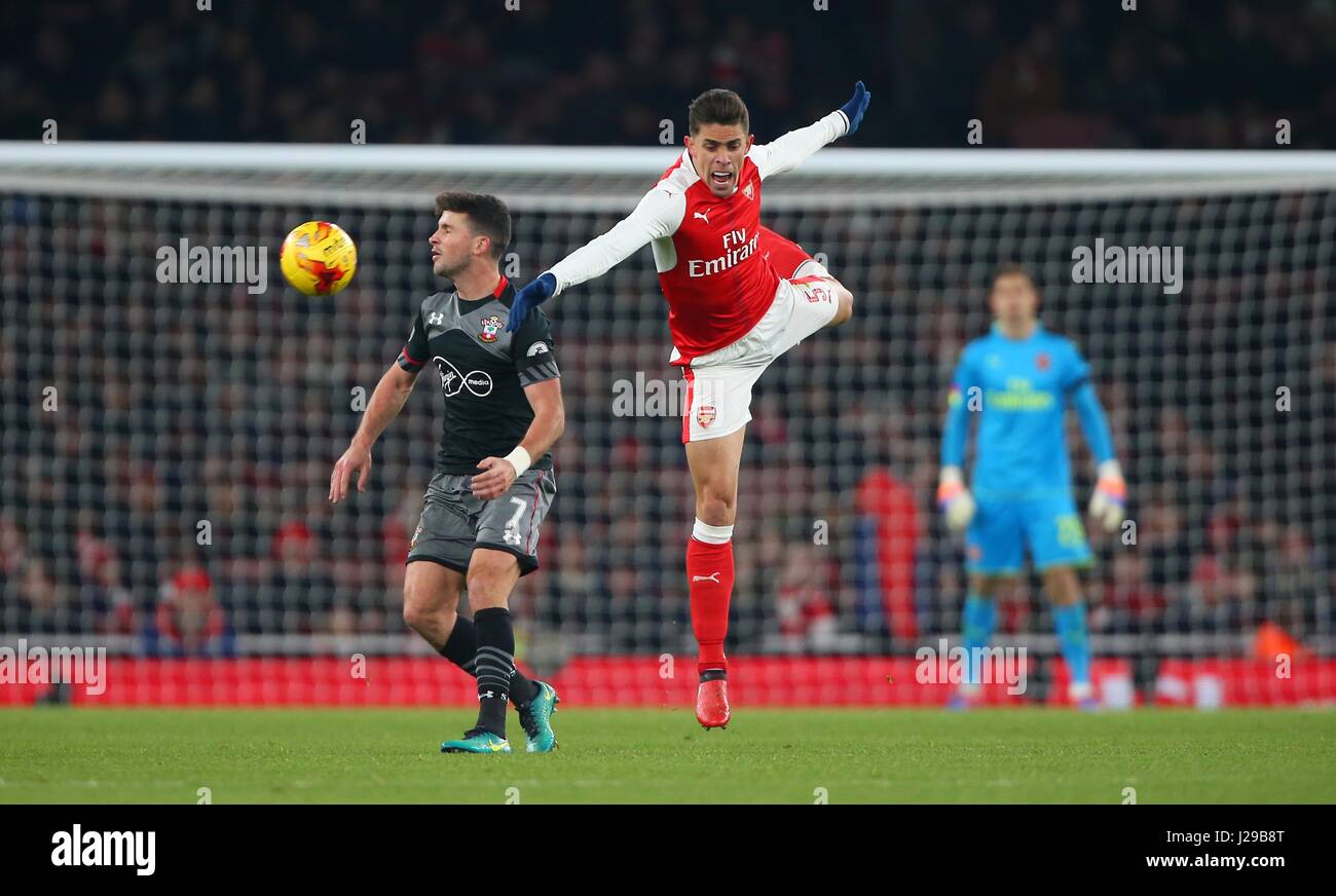 Arsenal's Gabriel Paulista challenges Shane Long of Southampton during the EFL Cup Quater-final match between Arsenal and Southampton at the Emirates Stadium in London. November 30, 2016. EDITORIAL USE ONLY - FA Premier League and Football League images are subject to DataCo Licence see www.football-dataco.com Stock Photo