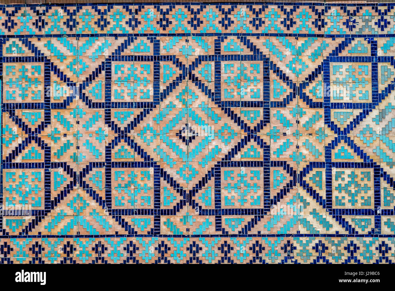 Colorful facade of mosaic and tiles of Registan mausoleum, Samarkand, Uzbekistan Stock Photo