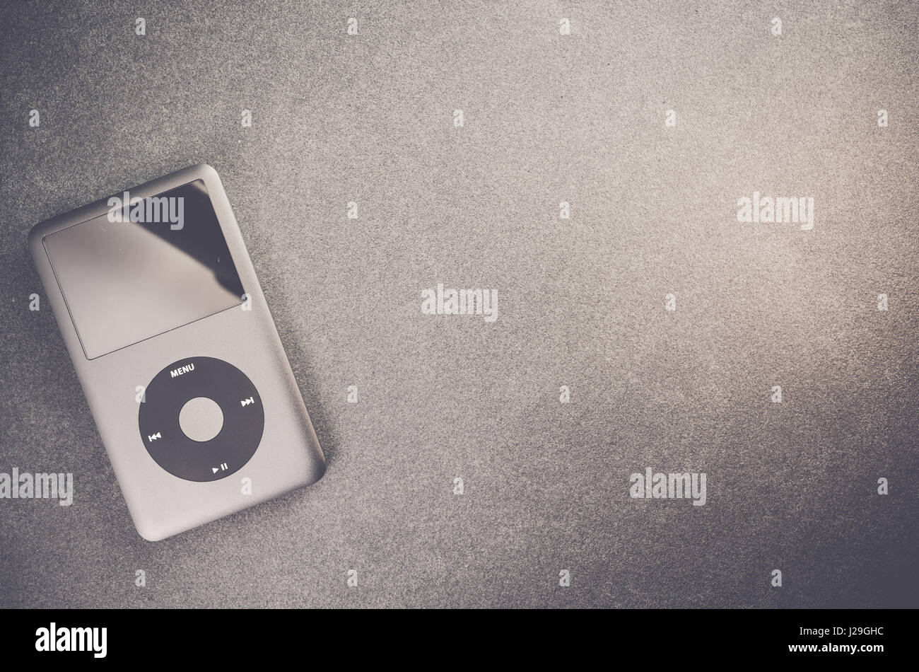 Apple ipod classic music player on a stone surface - top view Stock Photo