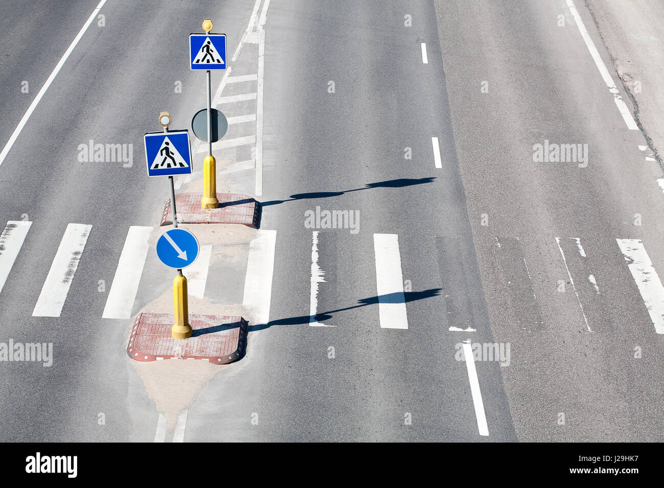 Zebra pattern pedestrian crossing with some road signs Stock Photo