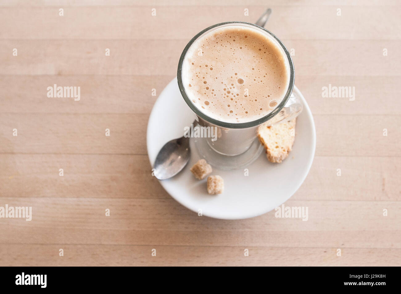 Latte coffee Sugar cubes Spoon Biscotti biscuit Cup Glass Coffee break Coffee time Refreshment Refreshing Interior Cafe Restaurant Stock Photo