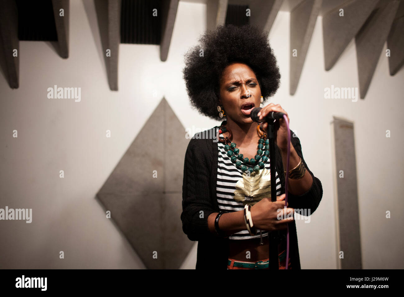 Singer performing in a recording studio Stock Photo - Alamy