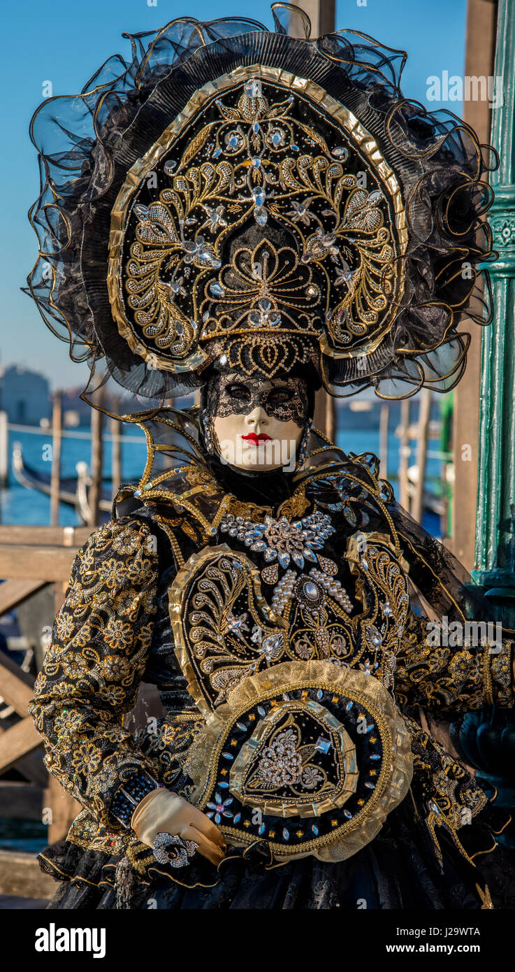 Four women in costume during the Carnival festival in St. Mark's Square in front of the Palace of the Doges in Venice, Italy. Stock Photo