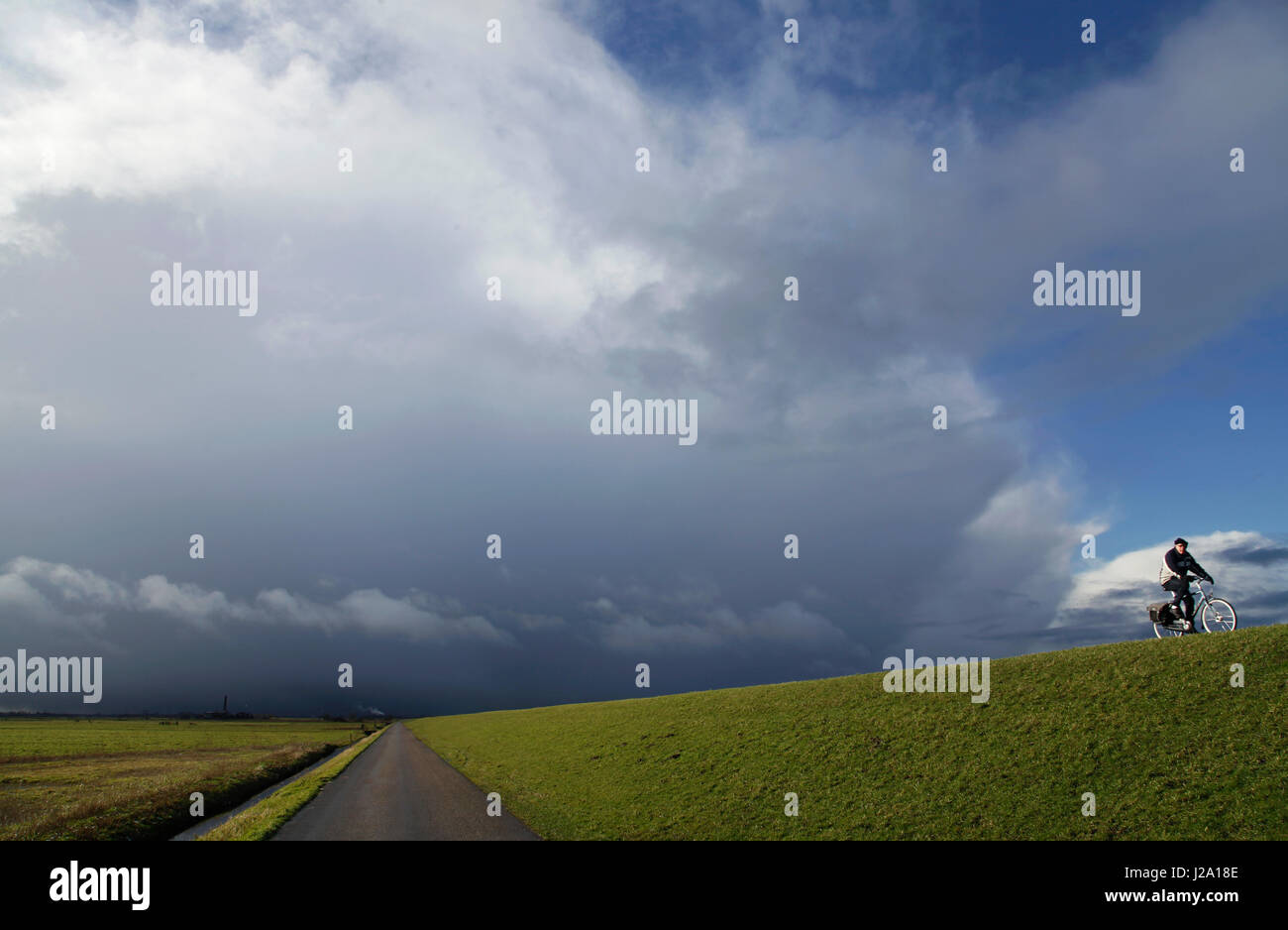 Rain clouds in a polder landscape. Stock Photo