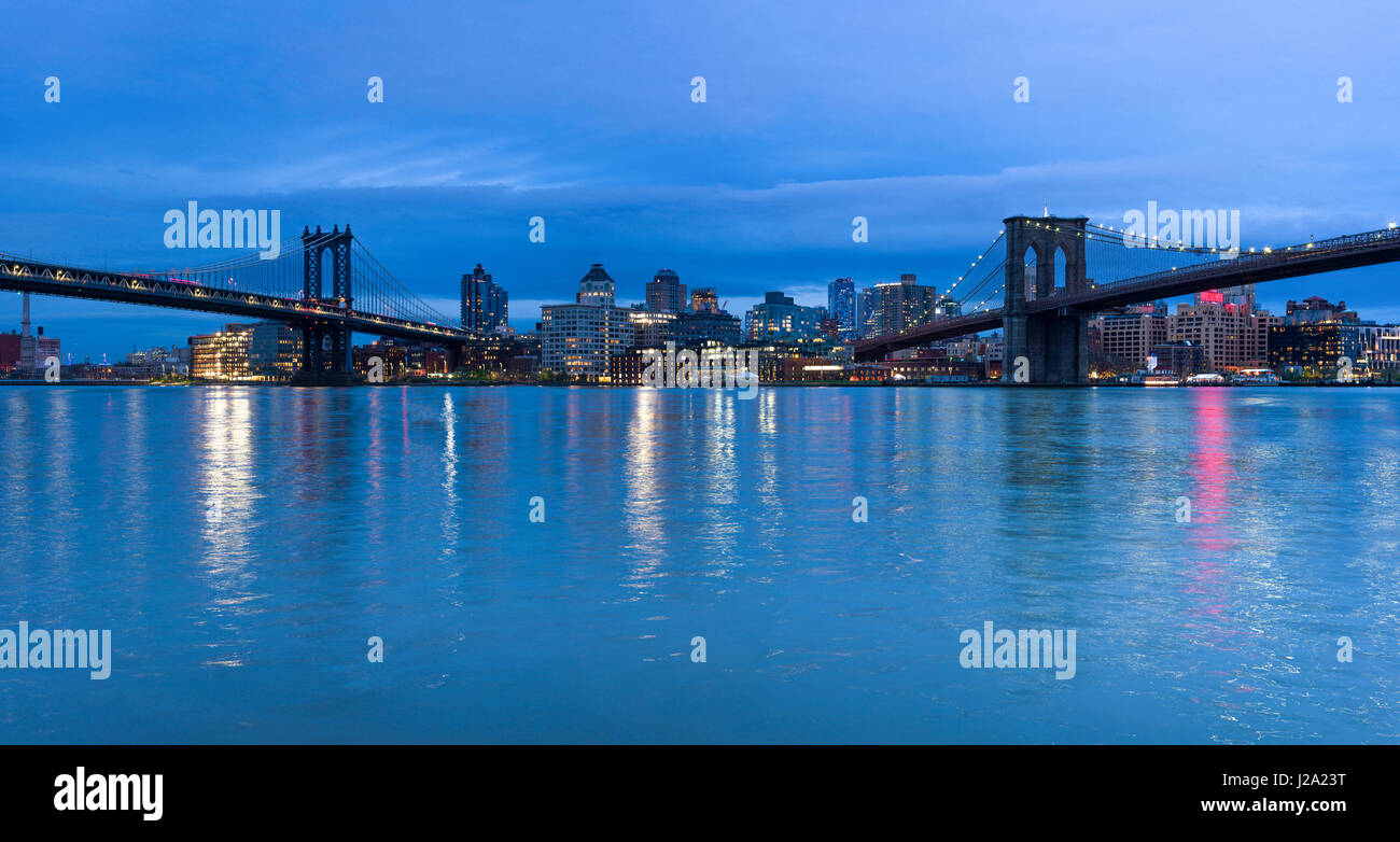 Manhattan And Brooklyn Bridge With DUMBO from across the East River at dusk, New York Stock Photo