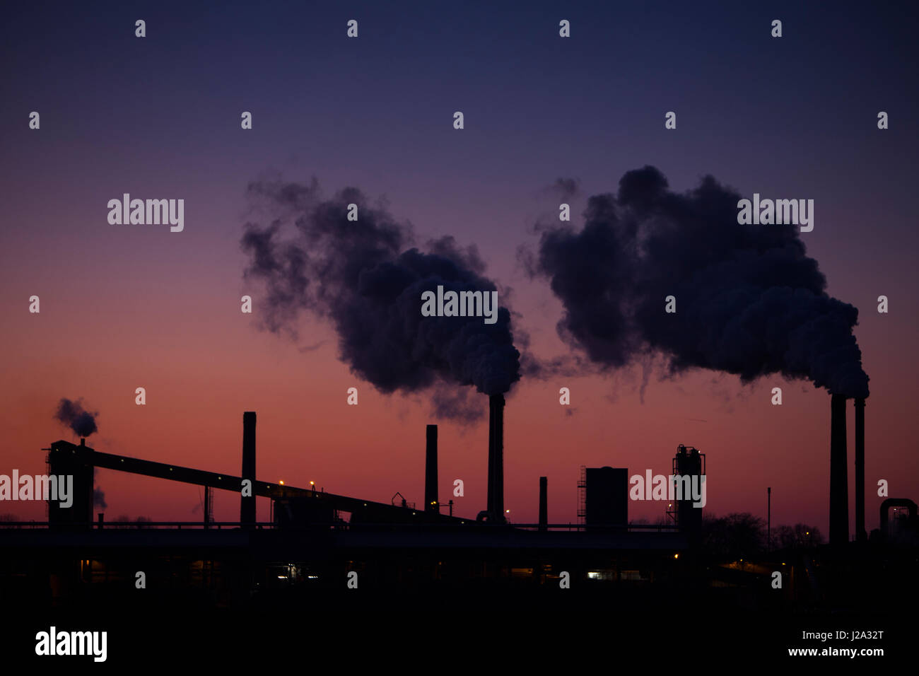 industrial emissions after sunset on a clear day in the winter Stock Photo
