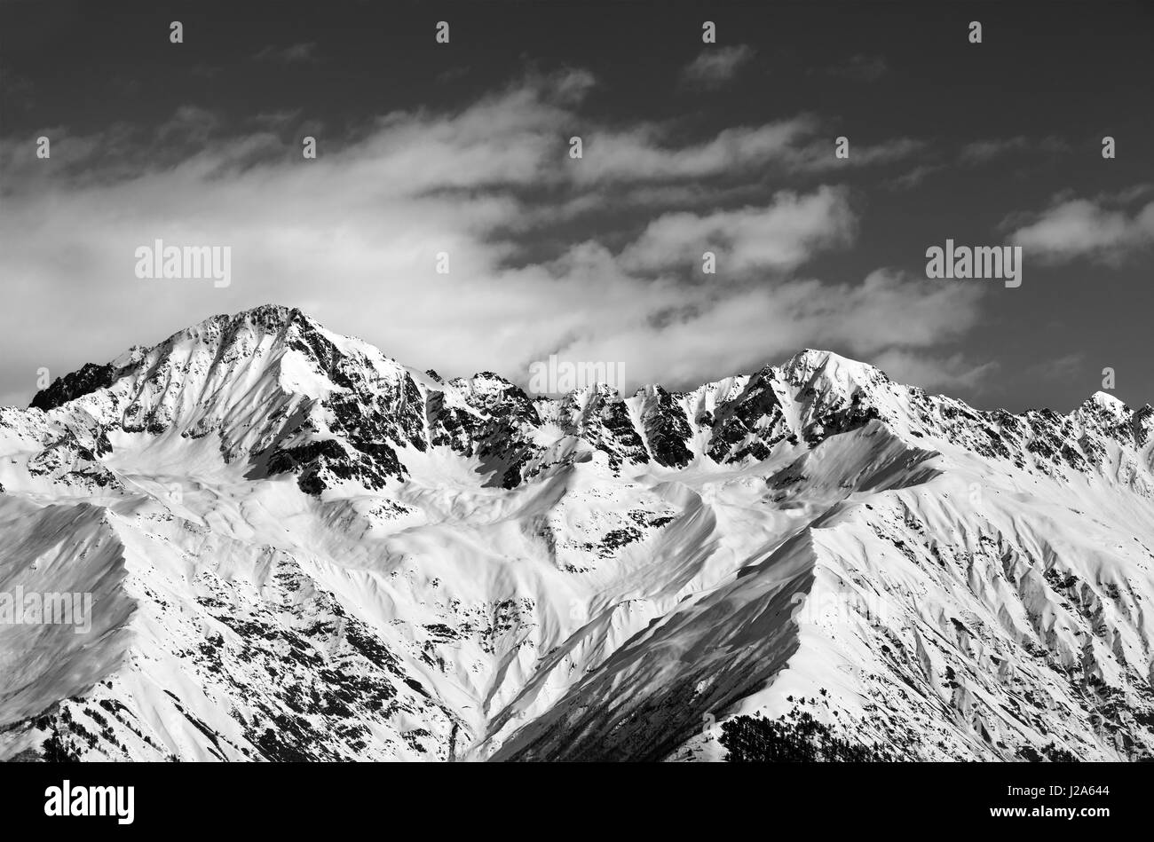 Black and white snow mountains in winter sun day. View from ski lift on Hatsvali, Svaneti region of Georgia. Caucasus Mountains. Stock Photo