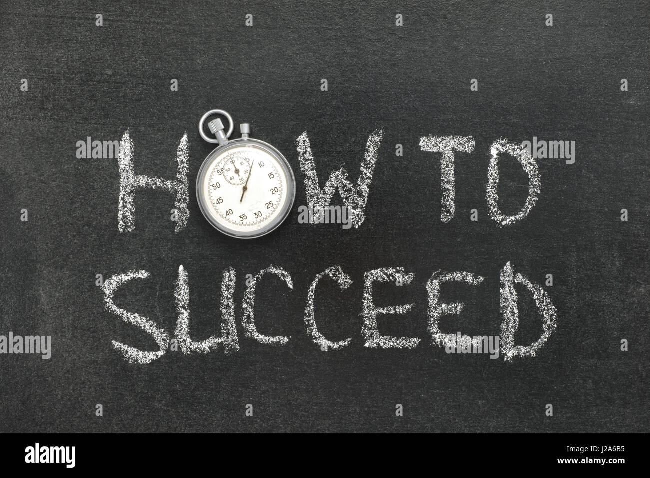 how to succeed phrase handwritten on chalkboard with vintage precise stopwatch used instead of O Stock Photo