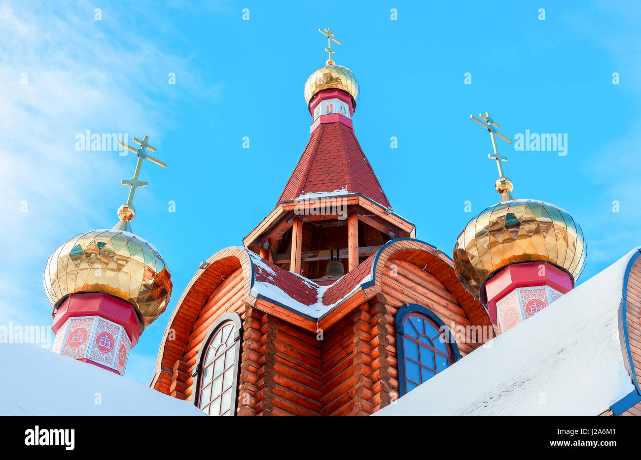 Domes with crosses on wooden orthodox church against the blue sky in ...