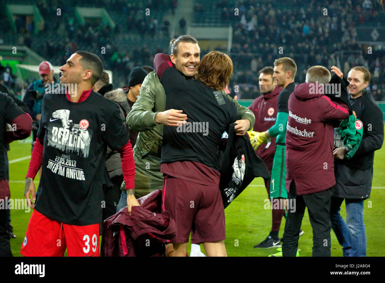 sports, football, DFB Cup, 2016/2017, Round 5, semifinal, Borussia Moenchengladbach vs Eintracht Frankfurt 7:8 on penalties, Stadium Borussia Park, Frankfurt players rejoicing at the win and the entry to the DFB Cup final 2017 in Berlin, Omar Mascarell (Frankfurt) left and the injured Alexander Meier (Frankfurt) in civvies Stock Photo